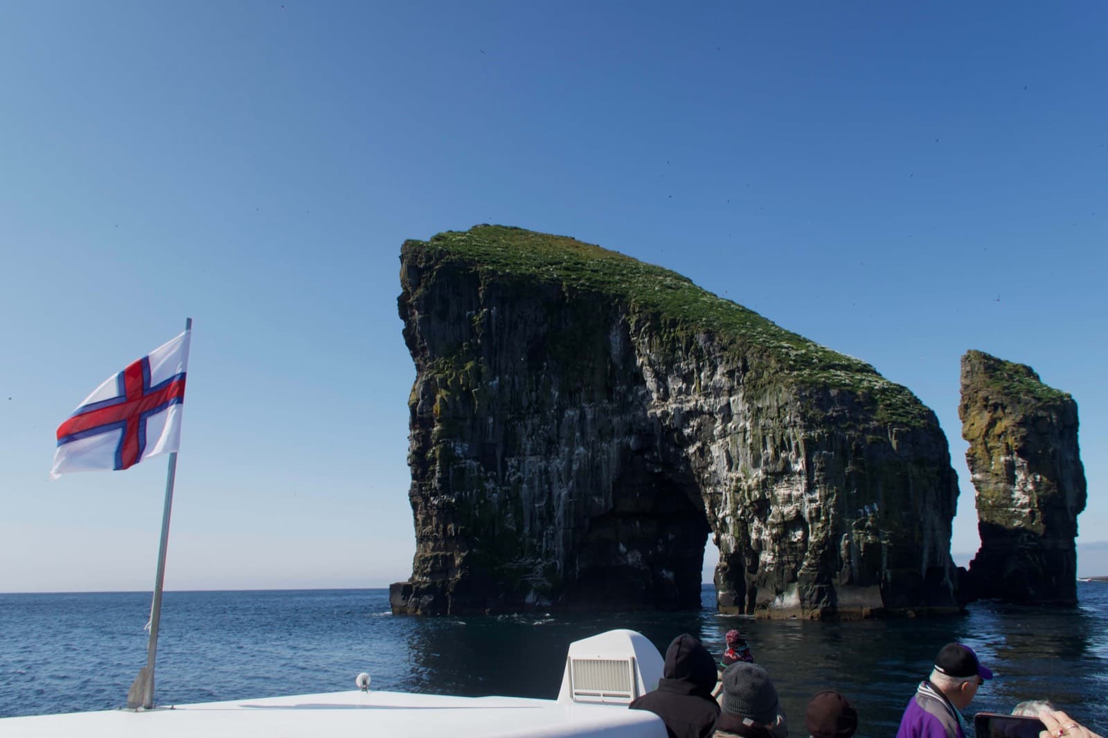 Drangarnir sea stacks with Faroese flag